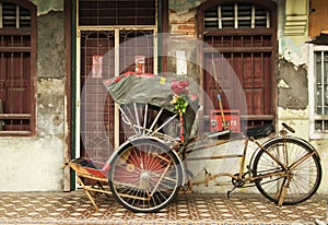 Old red rickshaw and heritage house, Penang, Malaysia photo