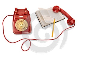 Old red rotating dial telephon with lined notebook