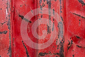 Old red rusty container with blows as background