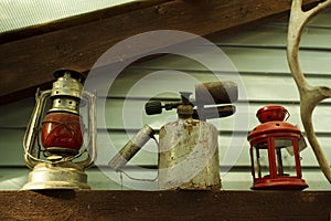 Old red Soviet kerosene lamp, which was hung on the last carriage of a freight train, blowtorch, candlestick and a piece