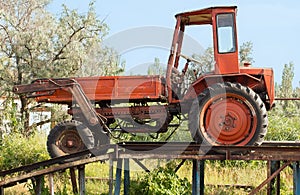 Old red tractor in the countryside