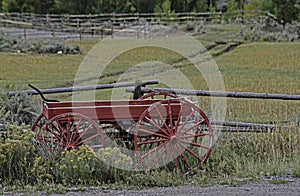 An old red wagon in the landscape in The Grand Tetons.