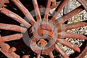 Old red wagon wheel with spokes and hub