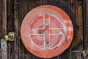 Old red weathered street sign on wood wall