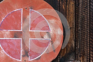 Old red weathered street sign on wood wall