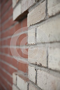 Old red and white brick wall with rich colorful grainy texture and details