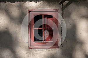 Old red window under the sunlight