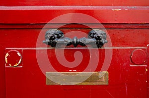 Old red wooden door with decorativel handle and Inbox