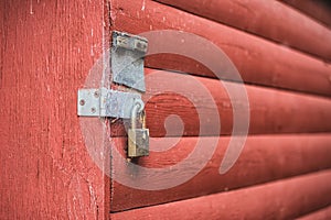 Old red wooden door texture background with door knob and rusty