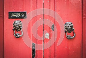 Old Red Wooden Doors with Lion Head Metal Knockers in Mdina, Malta