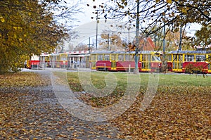 The old red and yellow trams in the tram terminus depot are standing and waiting