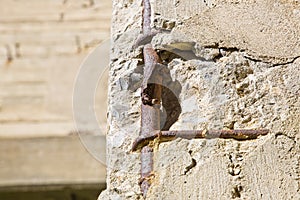 Old reinforced concrete structure with damaged and rusty metallic reinforcement bars