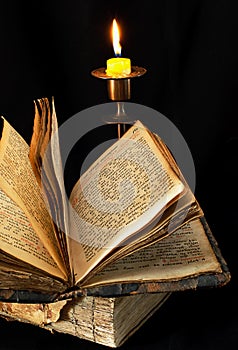 Old religious book and candle