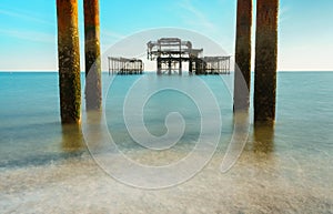 The old remains of Brighton Pier left standing in sea with beautiful waves in Brighton and Hove`s West Pier. Old vintage West Pie