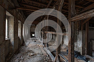 Old renovated palace, destroyed interior. Tunnel with wooden rafters