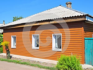 Old renovation house with new plastic siding walls and old asbestos roof.