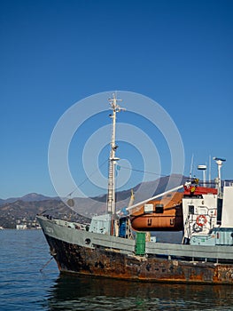 Old research ship in the port. Rusted schooner