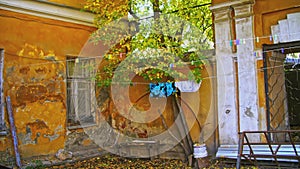 Old residential building facade with scuffed plaster. Stock footage. Old apartment building on a sunny day.