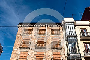 Old residential building with windows boarded up to prevent squatters from entering