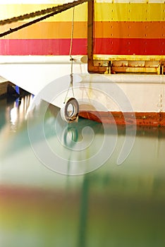 Old retired colorful ferry boat with calm sea water