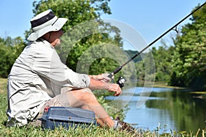 Old Retiree Outdoorsman Resting With Fishing Rod Fishing