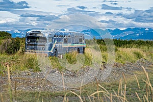 Old retro abandoned bus sits along in a marsh along the Homer Spit in Alaska