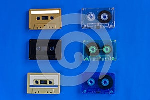 Old retro audio cassette tapes on blue background