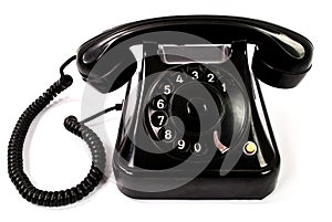 Old retro black phone isolated on a white background