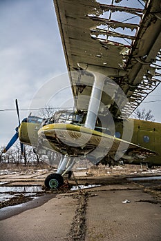 Old retro broken plane on the airfield side view