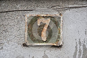 Old retro cast iron plate number 7
