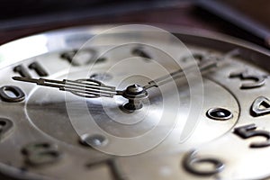 Old or retro clock winding, close-up hands and face of the old m