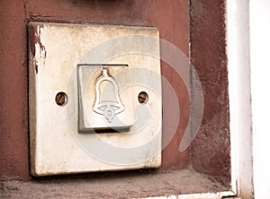 Old retro doorbell bell symbol button detail, macro, extreme closeup, nobody. Entrance door house bell signal system, vintage