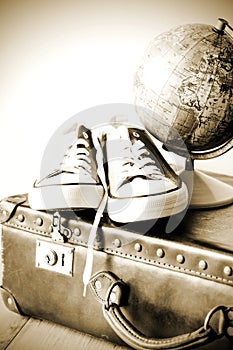 Old retro holiday suitcase and shoes for globetrotter photo