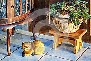 Old retro living room with ceramic cat, old side cabinet and plant as decoration