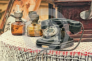 Old retro objects antique telephone and gas lamps on the table