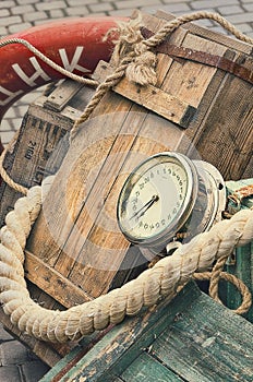 Old retro objects antique textural background wooden crates, chronometer and ropes photo