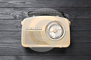 Old retro radio on black wooden background