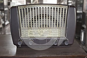 Old retro radio on wooden table.