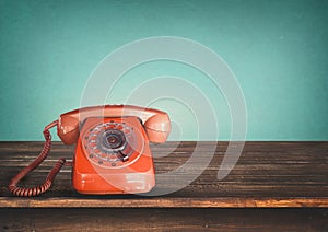 Old retro red telephone on table