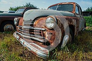 Old retro rusty abandoned and forgotten cars, cemetery of vintage autos photo