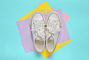 Old retro sneakers with white laces on a colored pastel background. Minimalism. Top View.