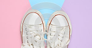 Old retro sneakers with white laces on a colored pastel background. Minimalism. Top View.