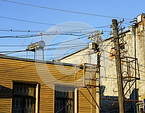 Old retro style wooden pole with many electric supply wires or cables for telephone communication