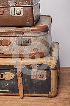 Old, retro, suitcases lie on the table with white background