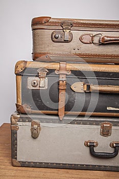 Old, retro, suitcases lie on the table with white background