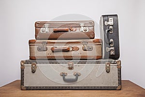 Old, retro, suitcases lie on the table with white background