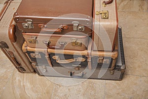 Old, retro, suitcases lie on the table with white background