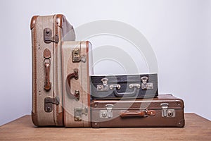 Old, retro, suitcases lie on the table with white background