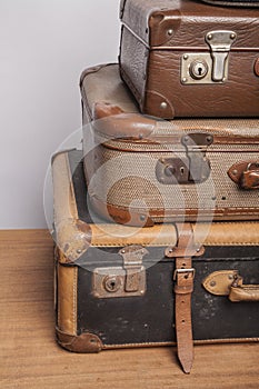 Old, retro, suitcases lie on the table with white background