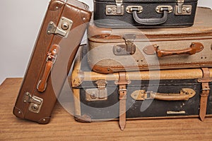 Old, retro, suitcases lie on the table with white background